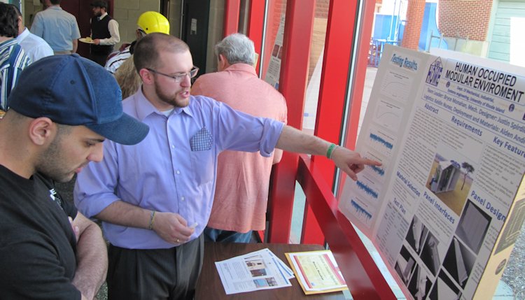 Bryce Monahan explaining the structural aspects to a fellow URI student during the Engineering Capstone Exhibition at Kirk Hall, Kingston, Rhode Island. May 2011.